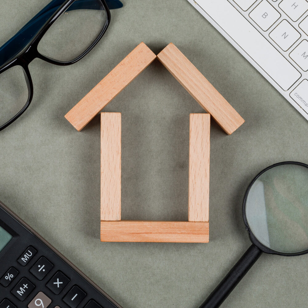 Maison en bois posé sur un table avec des objet autour