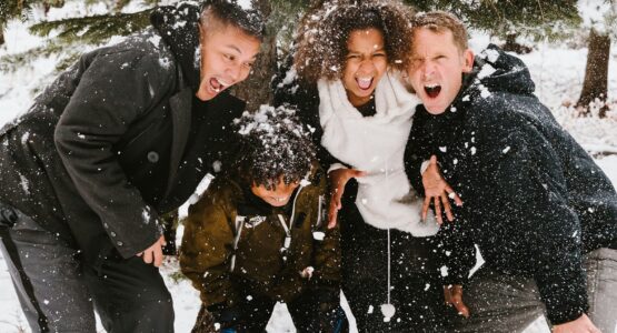 group of people standing on snowy field